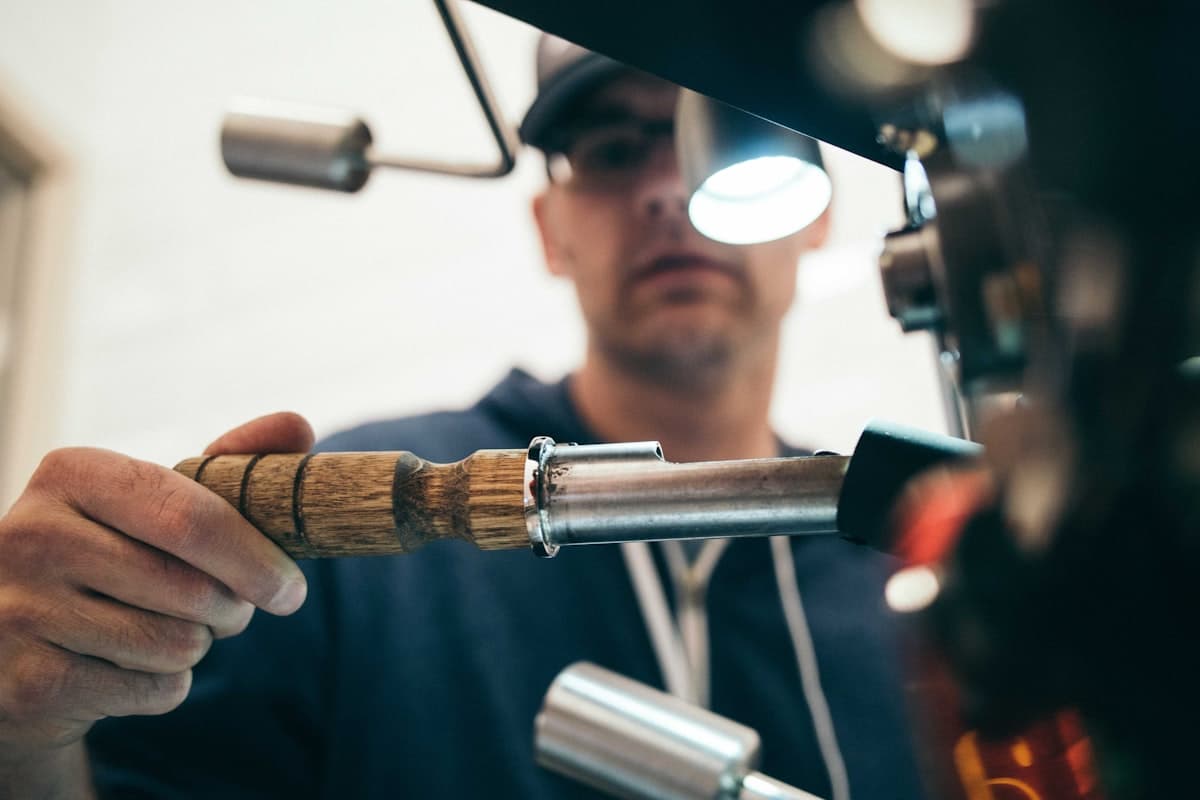 Technician closely inspecting a piece of equipment